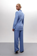 Baby blue hourglass co-ords suit by Joanna Andraos, featuring a fitted top and matching pants in soft pastel blue.