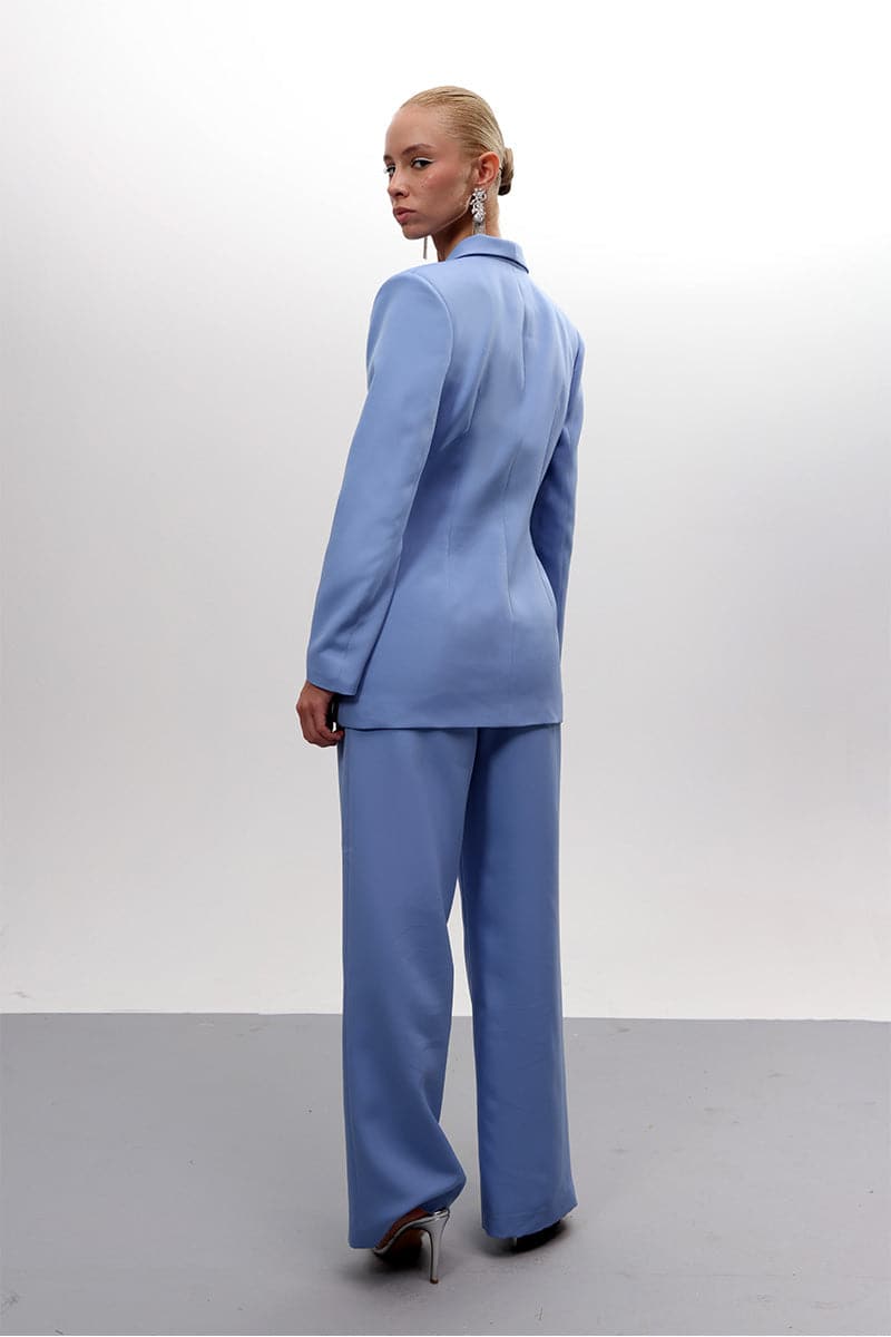 Baby blue hourglass co-ords suit by Joanna Andraos, featuring a fitted top and matching pants in soft pastel blue.