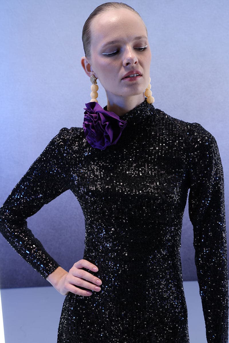 Full-length black sequins gown by Joanna Andraos, featuring a sleek, elegant design perfect for formal occasions.