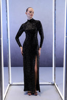 Full length black sequins gown by Joanna Andraos, featuring a sleek design and shimmering sequins, perfect for elegant occasions.