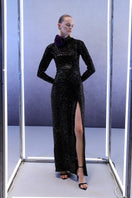 Full-length black sequins gown by Joanna Andraos, featuring a glamorous design and elegant fit, shown on a model.