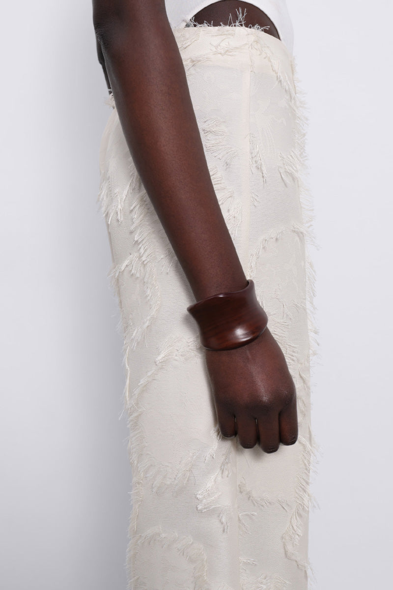 Cream Jora Fringe Trousers by SÉLONE featuring flowy fabric and fringe detailing, styled as casual or boho chic pants.