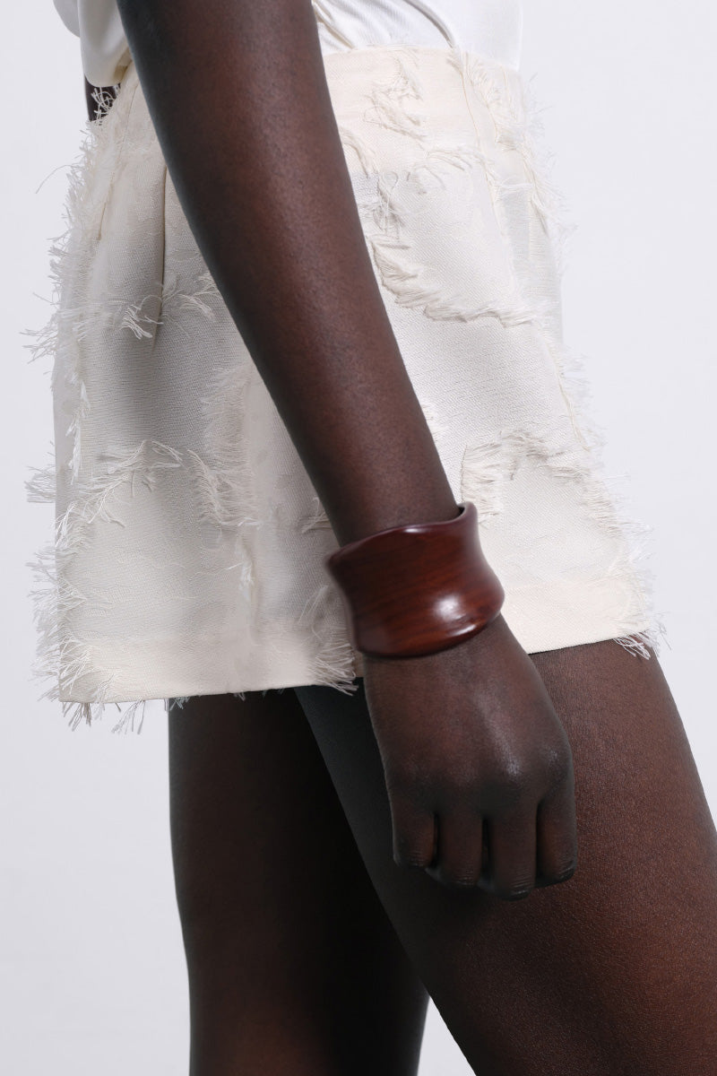 White Jora Fringe Shorts by SÉLONE featuring layered fringe detailing and a relaxed fit, shown on a model.