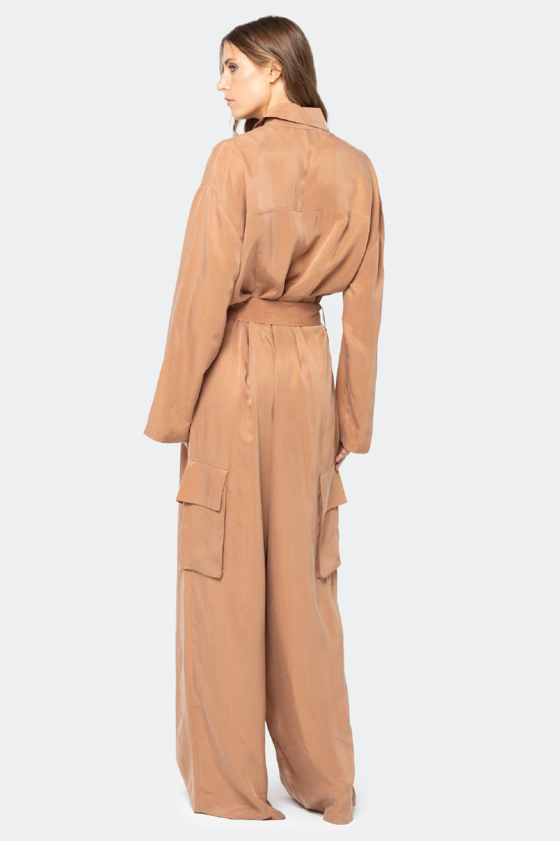 niLuu Serengeti Mocha jumpsuit displayed on a hanger, featuring a stylish, casual design with a fitted waist and wide-leg pants.