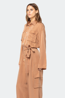 niLuu Serengeti Mocha jumpsuit displayed on a hanger, featuring a stylish mocha-colored fabric with a relaxed fit and adjustable straps.