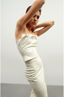 Ecru vegan leather draped top by Kris Marán, featuring a stylish, flowing design and textured fabric for a modern look.