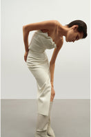 Vegan leather draped top in ecru by Kris Marán, featuring a stylish, flowing design and elegant draping detail.