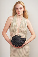 Emm Kuo Kahala woven circular clutch in black with sea shell design, featuring a stylish and textured woven pattern.