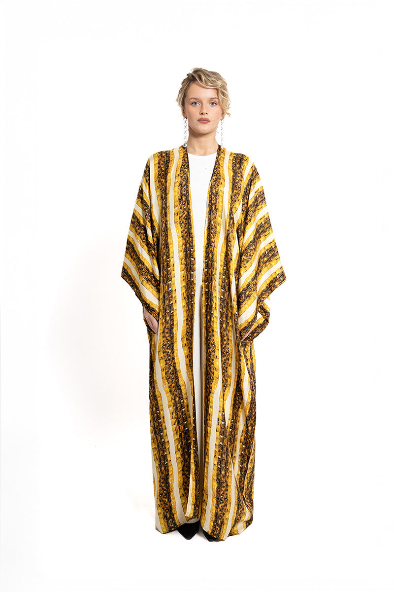 Gold Brocot kimono maxi dress by Amel Batita featuring elegant brocade fabric and flowing silhouette.