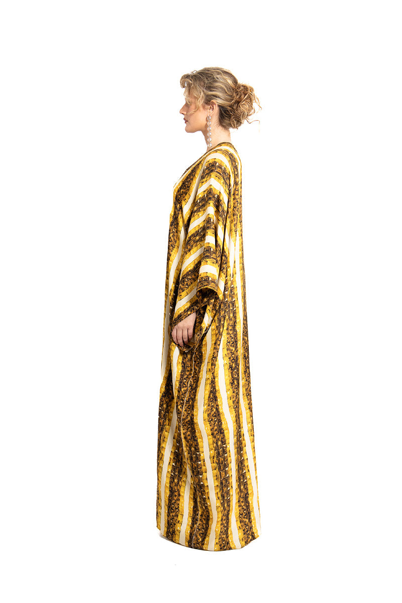 Gold Brocot kimono maxi dress by Amel Batita featuring flowing fabric and intricate brocot pattern, shown on a model.