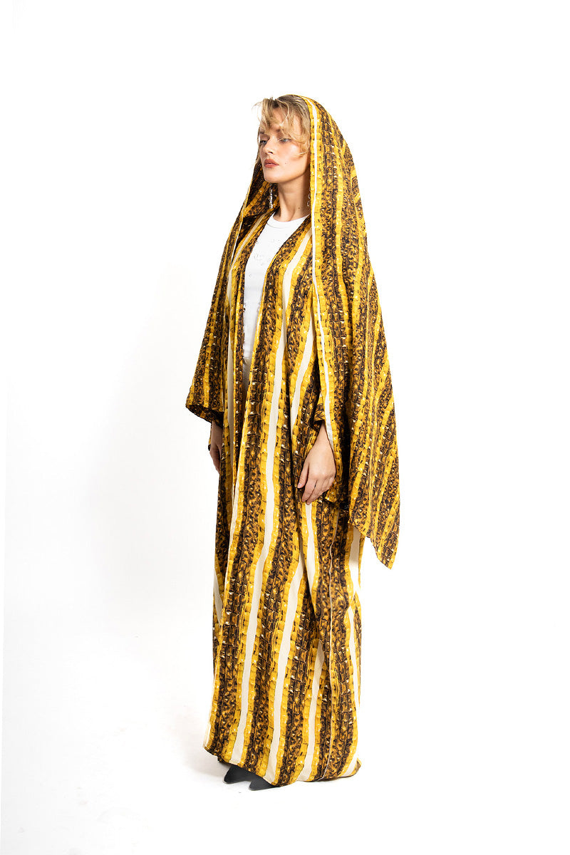 Gold Brocot silk kimono from Amel Batita featuring intricate brocade patterns, styled as a luxurious maxi dress or elegant outerwear.