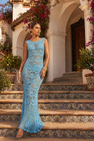 Handmade aqua shell crochet maxi dress by Andreeva featuring intricate crochet patterns and flowing fabric.