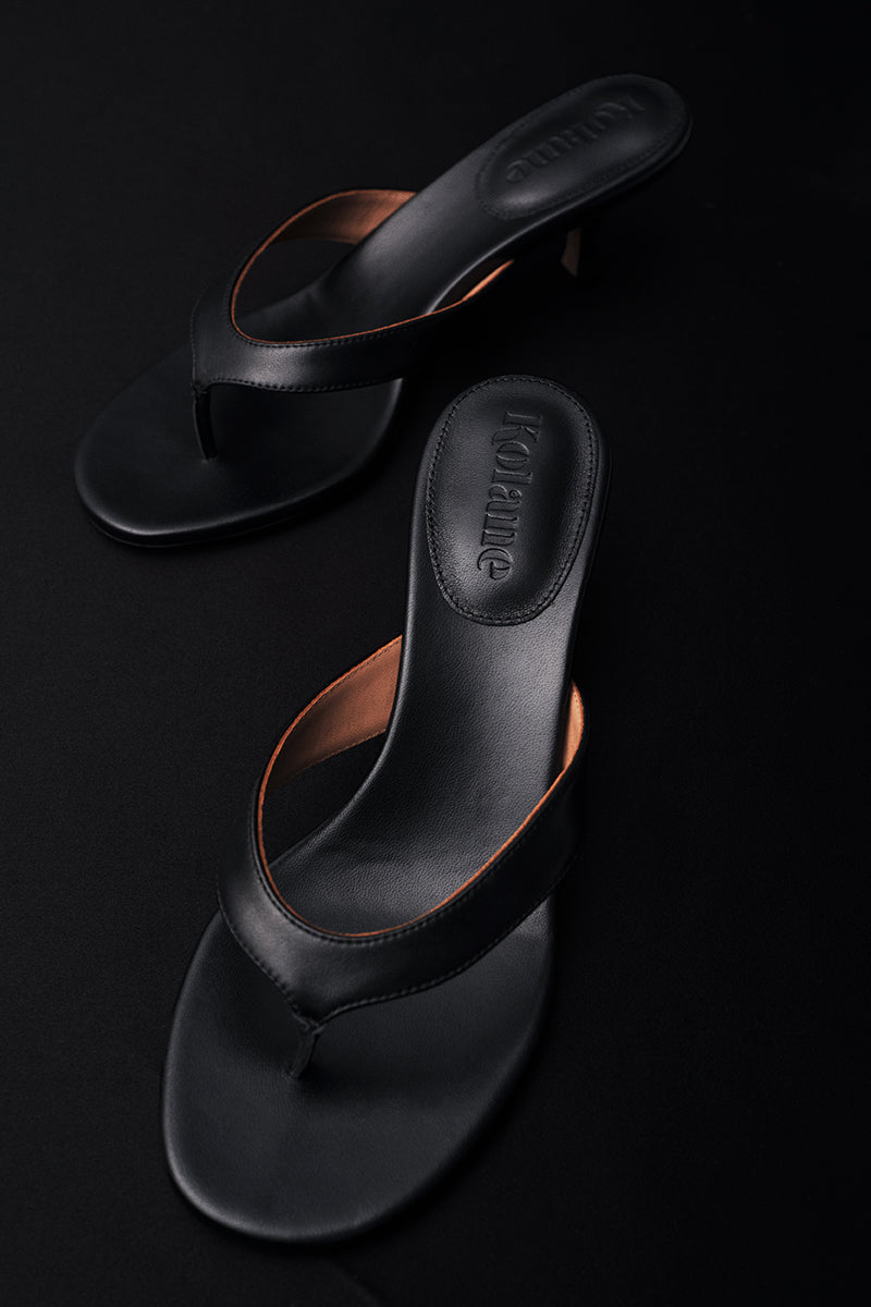 Black Annie Sandal by Kolane featuring a stylish design, shown in a close-up view highlighting the sandal's details.