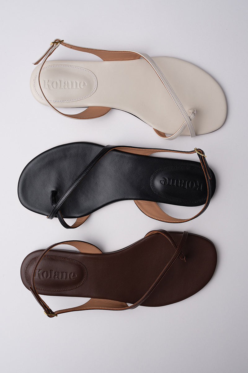 Kolane ESME ivory sandals with open-toe design and sleek straps, perfect for casual or dressy summer outfits.