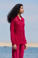 Pink raspberry-colored La Granni collared cardigan with button details, displayed on a hanger.