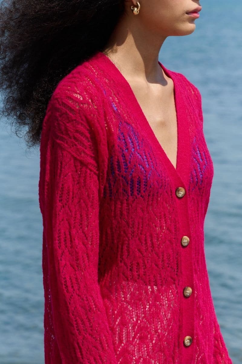 Pink raspberry-colored La Granni V-neck cardigan with aranita knit pattern, long sleeves, and cozy fit.