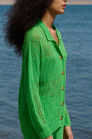 Green La Granni Arañita collared cardigan displayed on a model, featuring a cozy design and button-front closure.