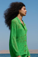 Green La Granni Arañita collared cardigan with long sleeves and button front, styled on a model.