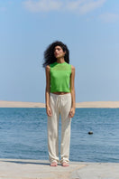 Lime green La Granni cropped vest cardigan with V-neck and long sleeves, displayed on a plain background.
