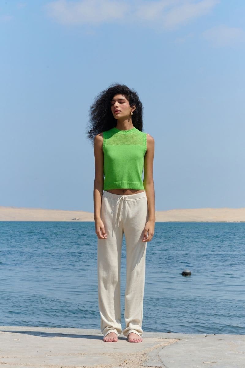 Lime green La Granni cropped vest cardigan with V-neck and long sleeves, displayed on a plain background.