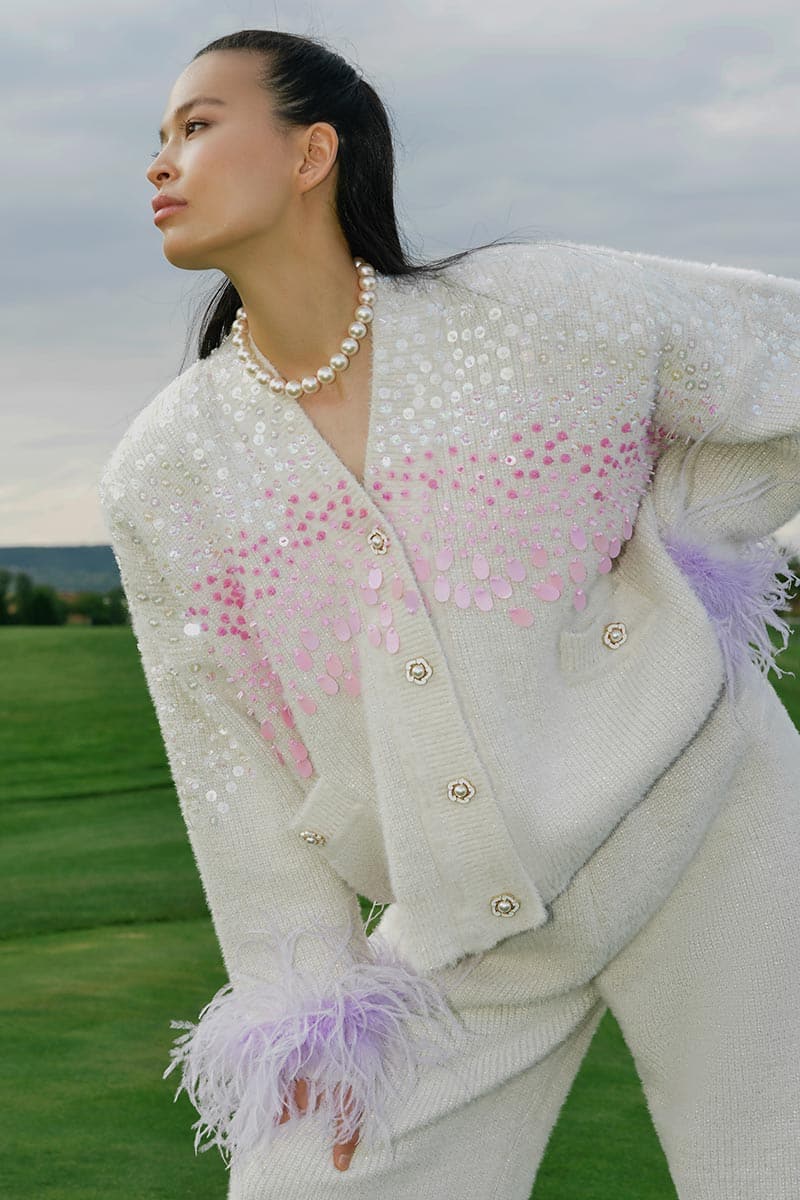 Lalo knitted cream co-ord set with feather cuffs, featuring a cozy knit texture and elegant feather detailing on the cuffs.