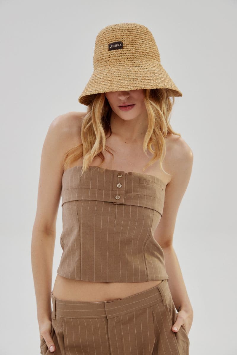 Beige LE SH KA natural bucket hat made of lightweight fabric, featuring a classic wide brim for sun protection.