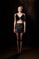 Black EVA crop top and mini skirt co-ord set by Le Thanh Hoa, featuring a stylish matching two-piece outfit.