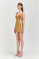 Le Thanh Hoa golden floral mini dress shown on a model, featuring a short length and elegant floral pattern.