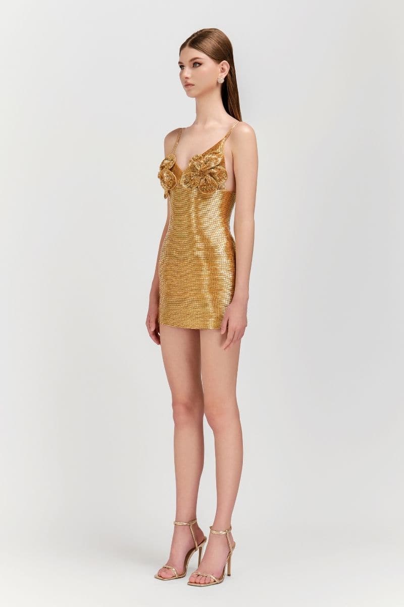 Le Thanh Hoa golden floral mini dress shown on a model, featuring a short length and elegant floral pattern.