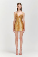 Le Thanh Hoa golden floral mini dress shown on a model, featuring a stylish mini length and vibrant floral pattern.