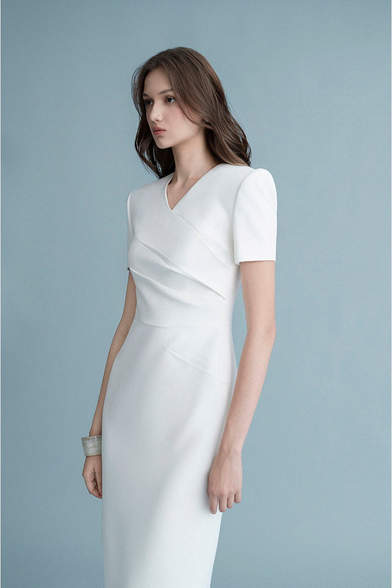 White LEKIEU BONN midi dress with a flowy, elegant design, displayed on a hanger against a neutral background.