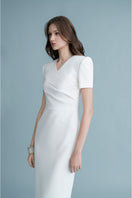 White LEKIEU BONN midi dress with a flowy, elegant design, displayed on a hanger against a neutral background.