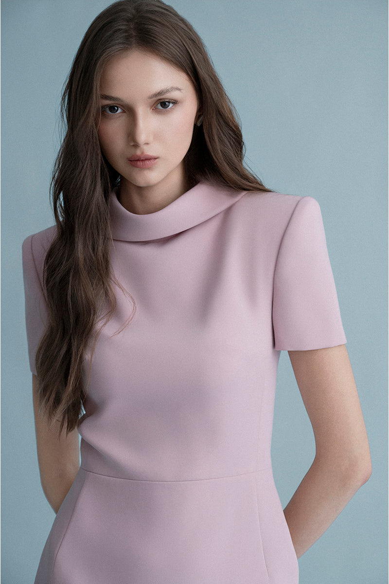 Pink Nimes midi dress by Lekieu, featuring a flowing fabric and elegant design, displayed on a hanger.