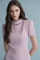Pink Nimes midi dress by Lekieu, featuring a flowing fabric and elegant design, displayed on a hanger.