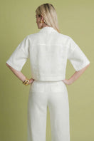 White Lina shirt by Laura Escobar, lightweight cotton blouse with classic collar and button-front design.