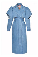 Liya Aqua Denim Cut-Out Trench Coat displayed on a hanger, showcasing its stylish design and unique cut-out details.
