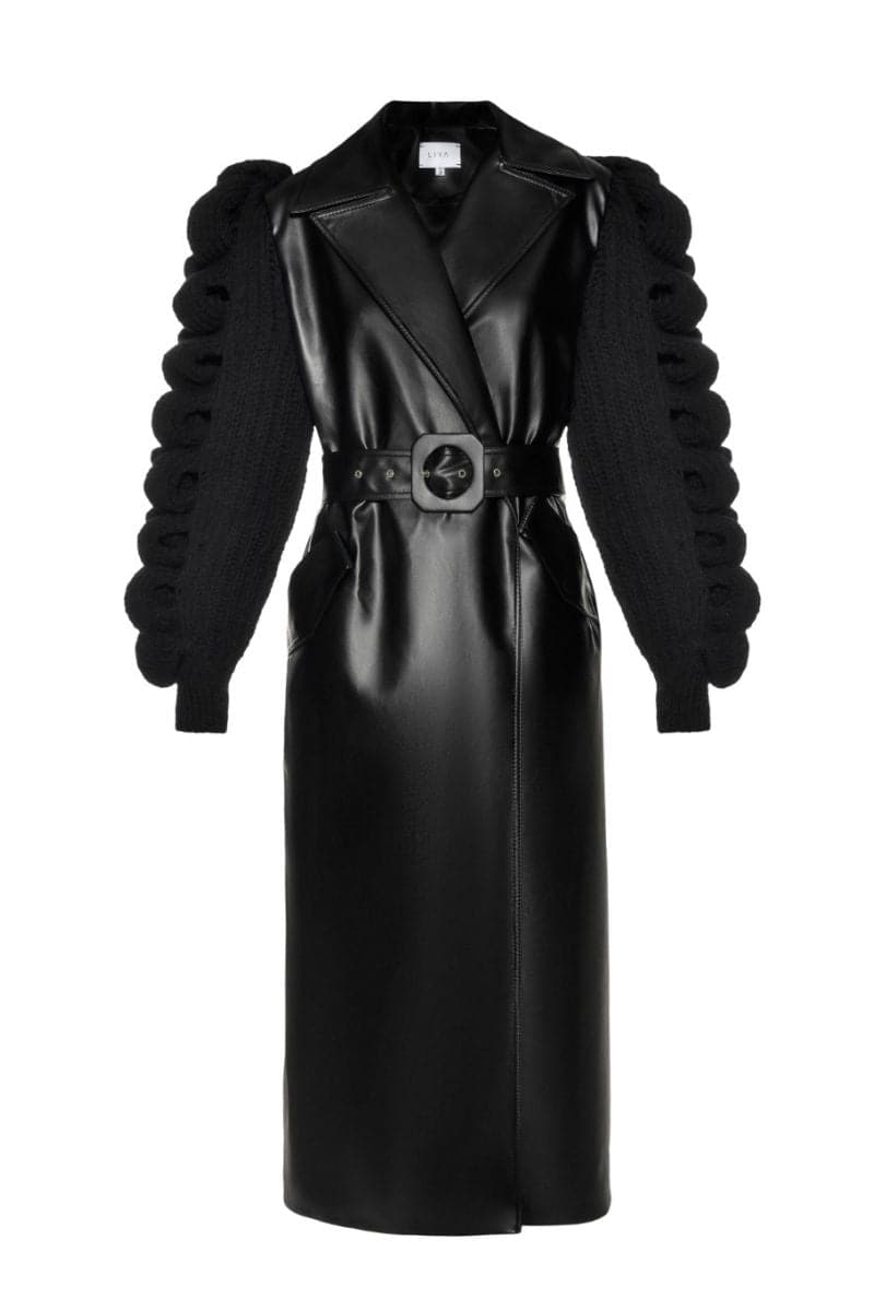 Black Liya trench coat for women, stylish and tailored with classic design, shown on a model in a fashion photo.