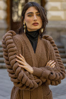Dark brown Liya hand-knitted coat with a cozy, textured knit pattern, displayed on a neutral background.