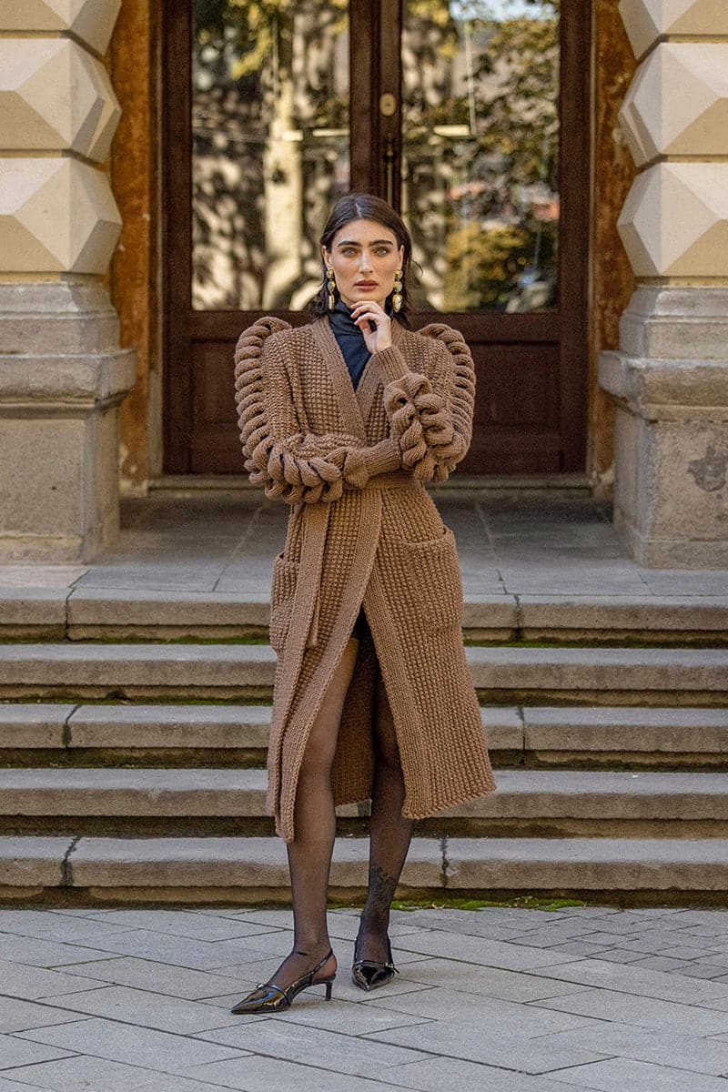 Dark brown hand-knitted coat by Liya, featuring textured knit details and a cozy, stylish design for cold weather.