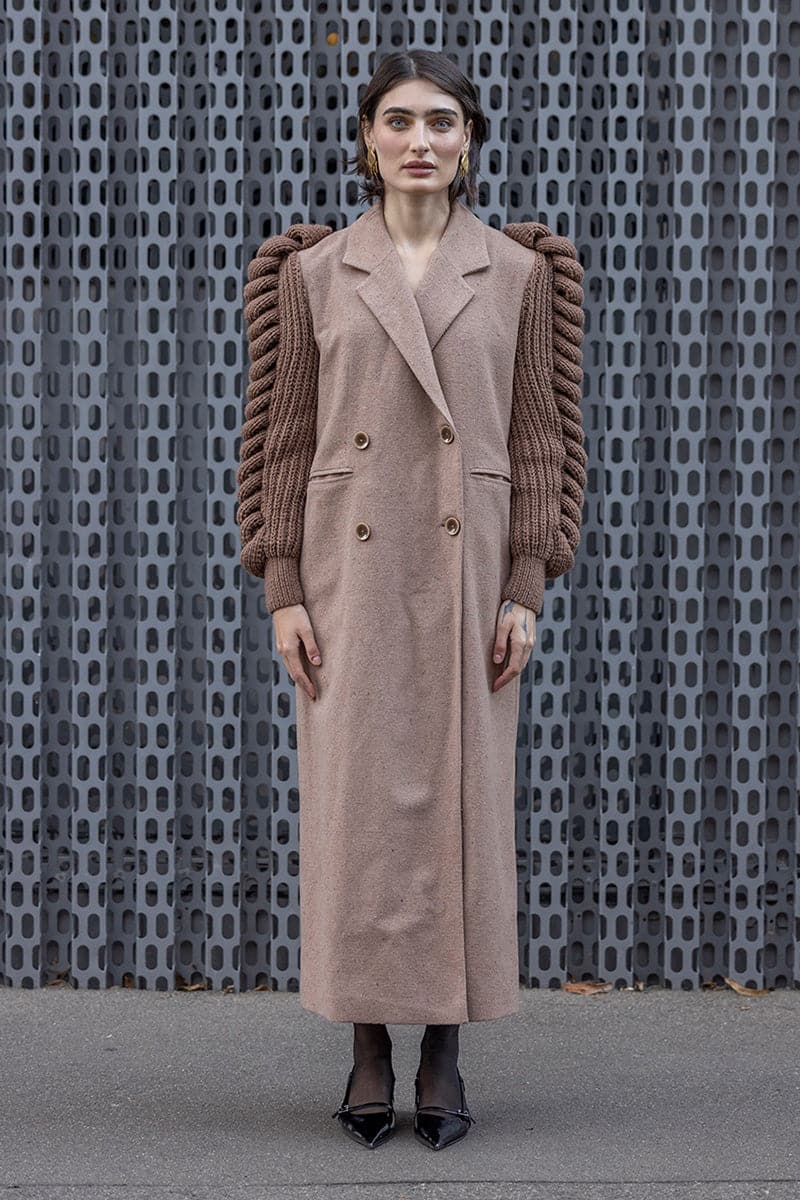 Liya camel double-breasted knitted sleeves coat in camel brown, featuring a stylish collar and button closure.
