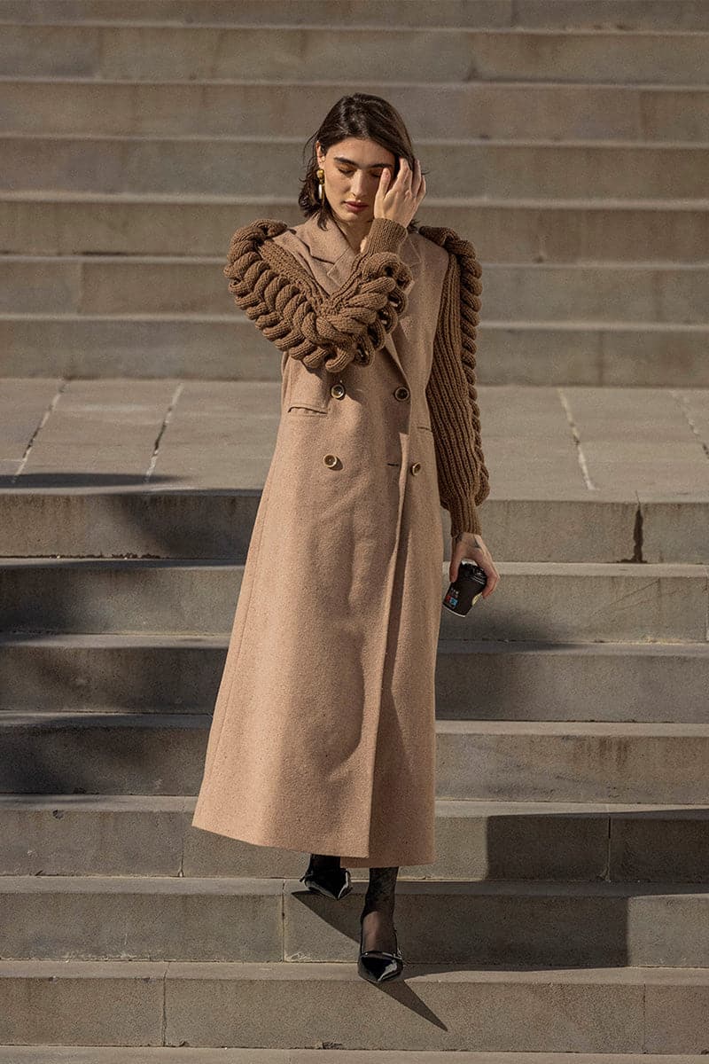 Liya camel double-breasted knitted sleeves coat on a model, featuring a warm camel brown color and stylish design.