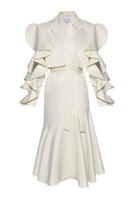 Liya ivory trench coat displayed hanging, featuring classic double-breasted design with belt and tailored fit.