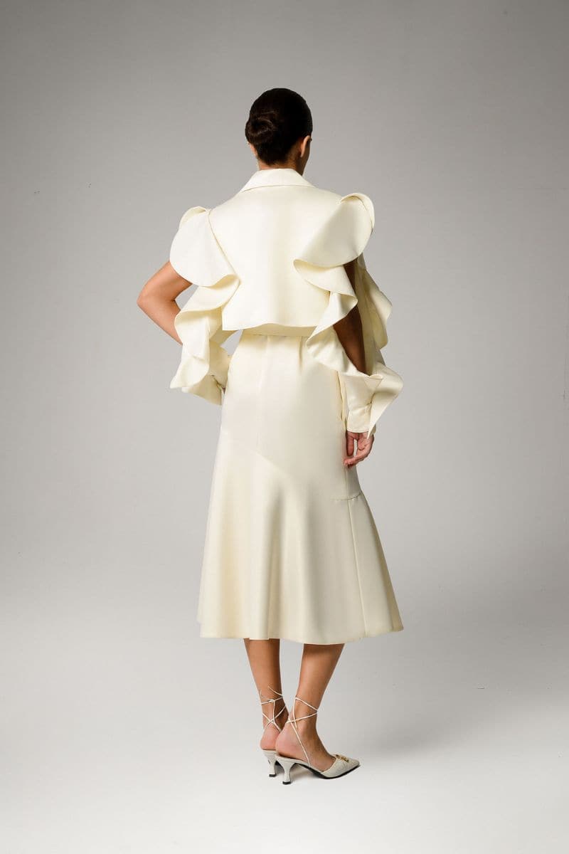 Liya ivory trench coat displayed on a hanger, featuring classic double-breasted design, belt, and tailored fit for women.