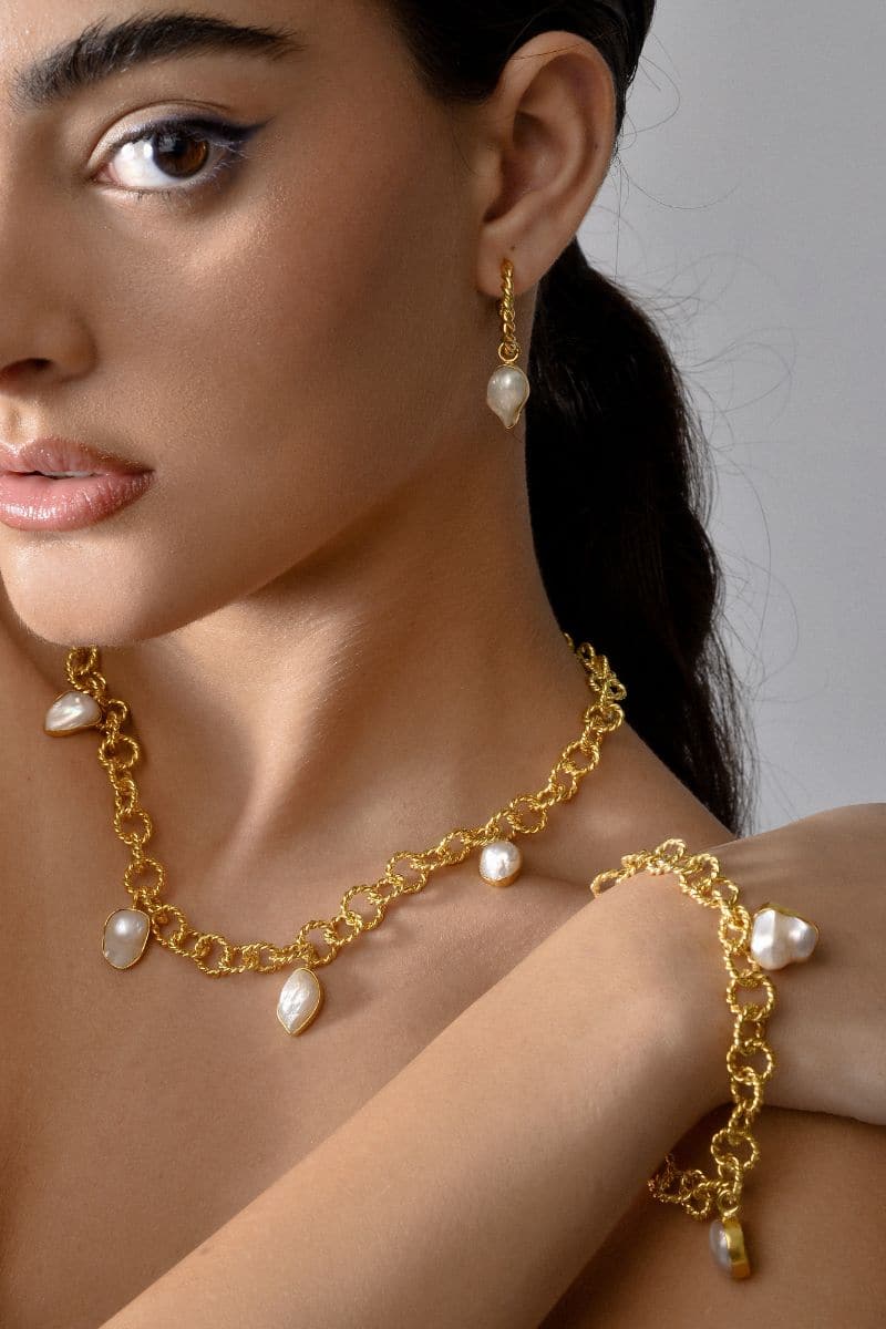 Liya Pearline Charm Bracelet in gold with delicate charms, stylish jewelry accessory for women