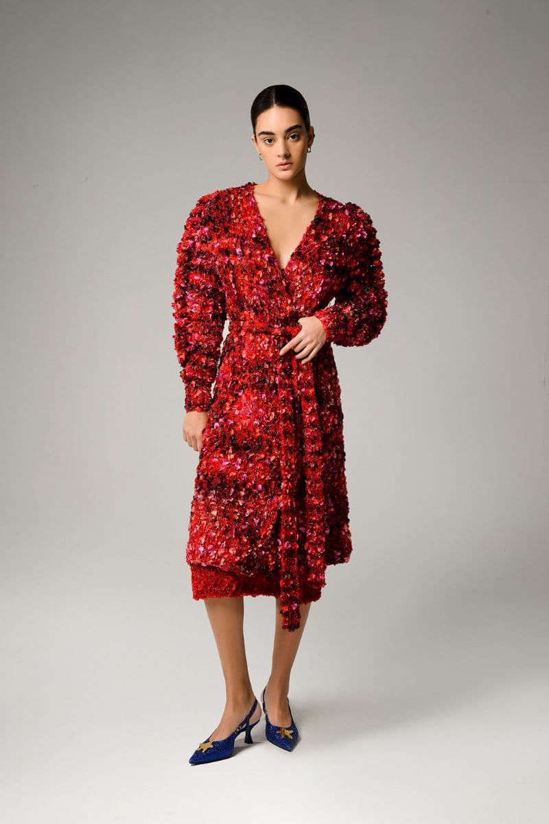 Liya Poppy knitted cardigan in red and black with button details, displayed on a hanger.