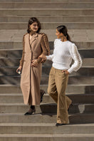 Liya white turtleneck sweater with a cozy fit, showcasing a classic snow-white knit design on a model.