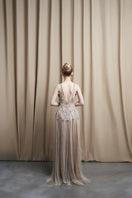 Beige spaghetti strap embroidered gown with beaded tulle skirt by HACCHIC COUTURE, elegant formal evening wear.