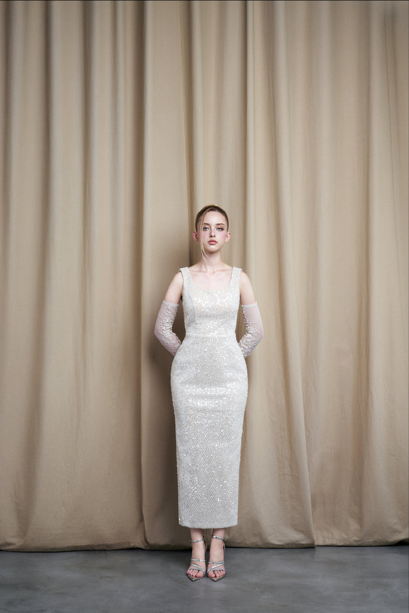 Ivory sequin gown with a scoop neck from HACCHIC COUTURE, featuring elegant fabric and intricate sequin detailing.