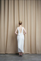 Ivory sequin gown with scoop neck and bow accents from HACCHIC COUTURE, elegant evening dress with shimmering sequins and bow details.