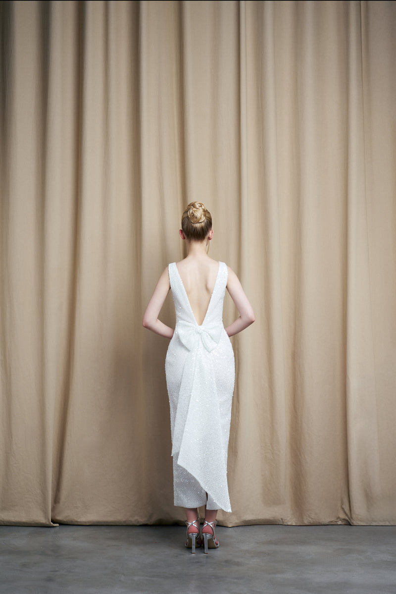 Ivory sequin gown with scoop neck and bow accents from HACCHIC COUTURE, elegant evening dress with shimmering sequins and bow details.